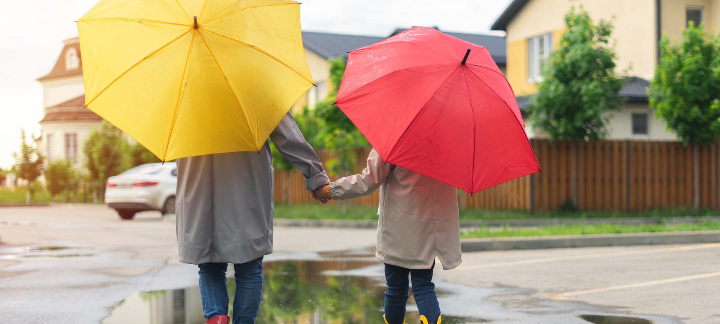 2 people walking with umbrella